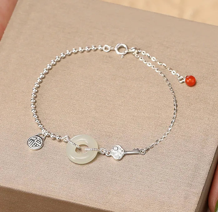 Women's silver bracelet with Hetian jade and geometric peace buckle design in Chinese style