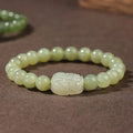 Grey Hetian jade ethnic style bracelet with polished beads on a wrist.