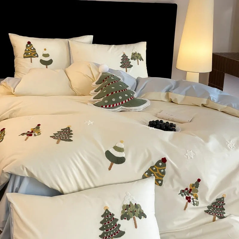 Cream blue duvet cover with raised towel embroidery of Christmas trees and flowers, part of a four-piece pure cotton bedding set.