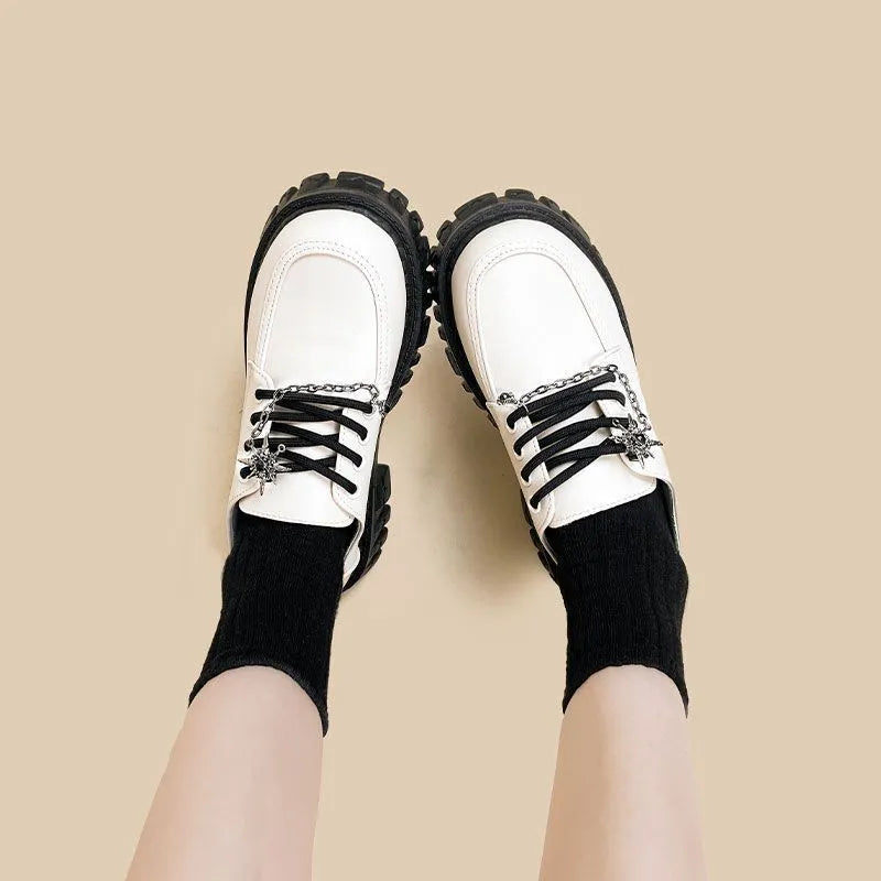 Women's preppy style loafers in Duke Asterism colour with a cross strap and metal buckle.