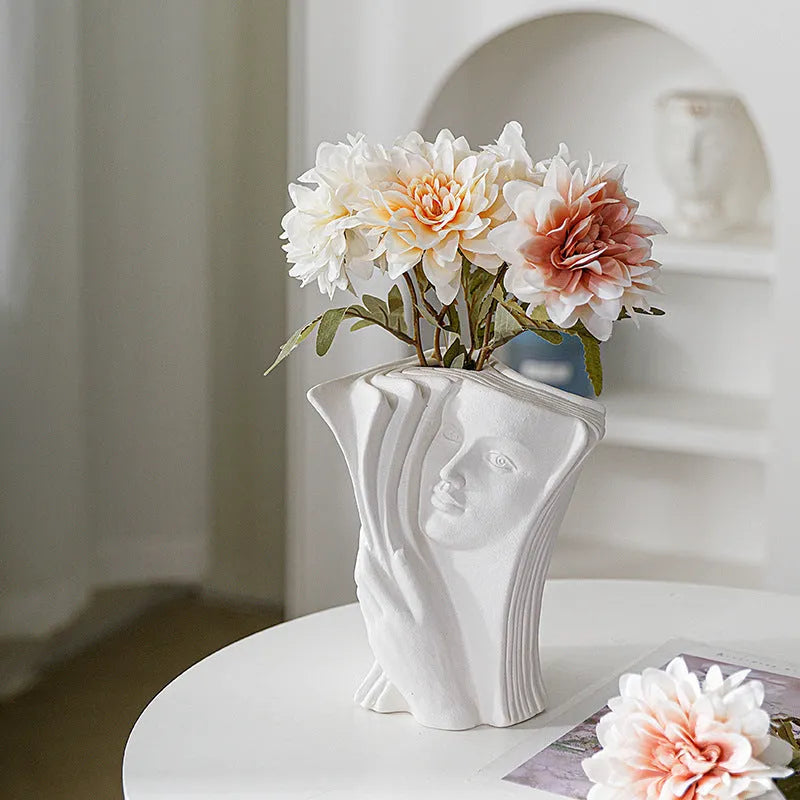 Ceramic book stand with glazed finish in a modern minimalist design on a desktop.