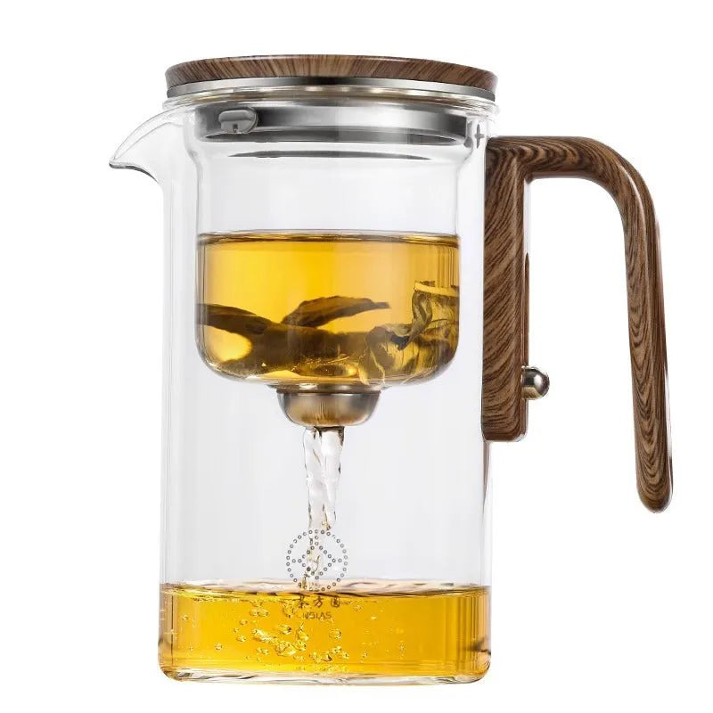 Glass teapot with wooden handle showing magnetic separation inner container and drip-free spout.