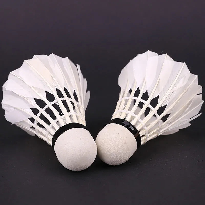 Twelve white training badminton shuttlecocks with feather skirts and cork bases arranged in a pack