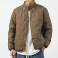 Men's black diamond lattice quilted cotton-padded jacket with extended length and loose fit.