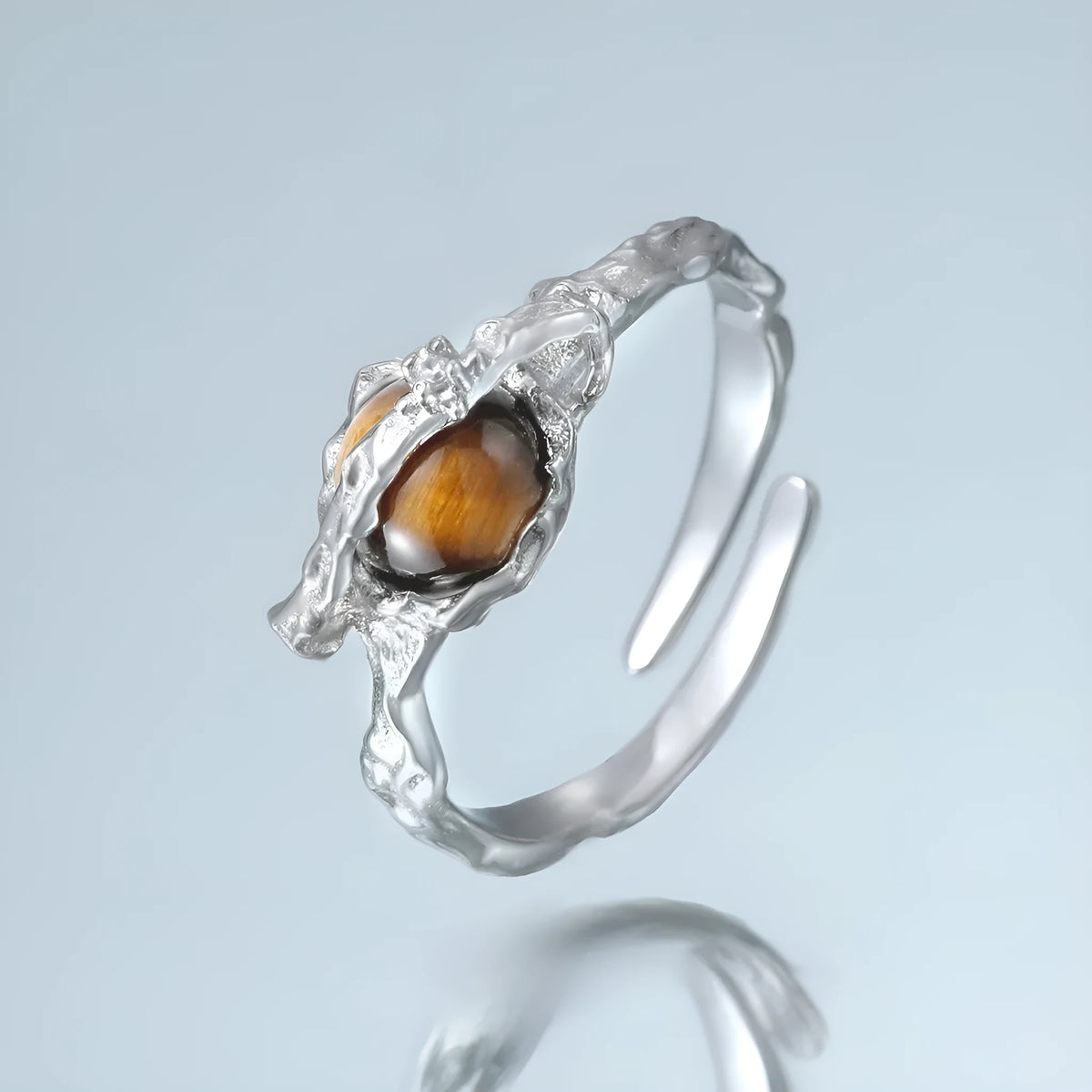 Silver Saturn open ring with tigereye detail and white gold-coloured electroplated finish, adjustable opening