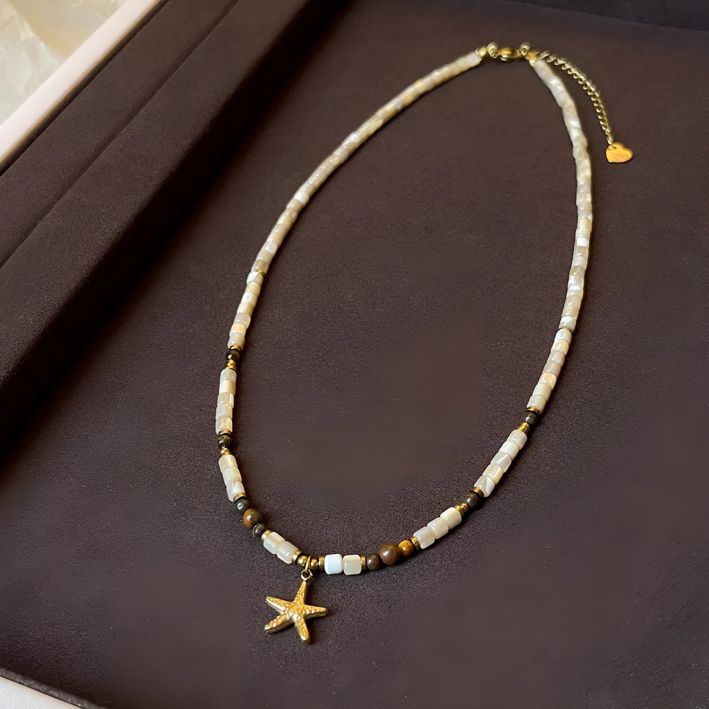 Titanium steel starfish pendant necklace with natural shell and tigereye beads on a 41-50cm chain.