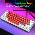 White and black wired 61-key USB membrane keyboard on a desk next to a laptop.