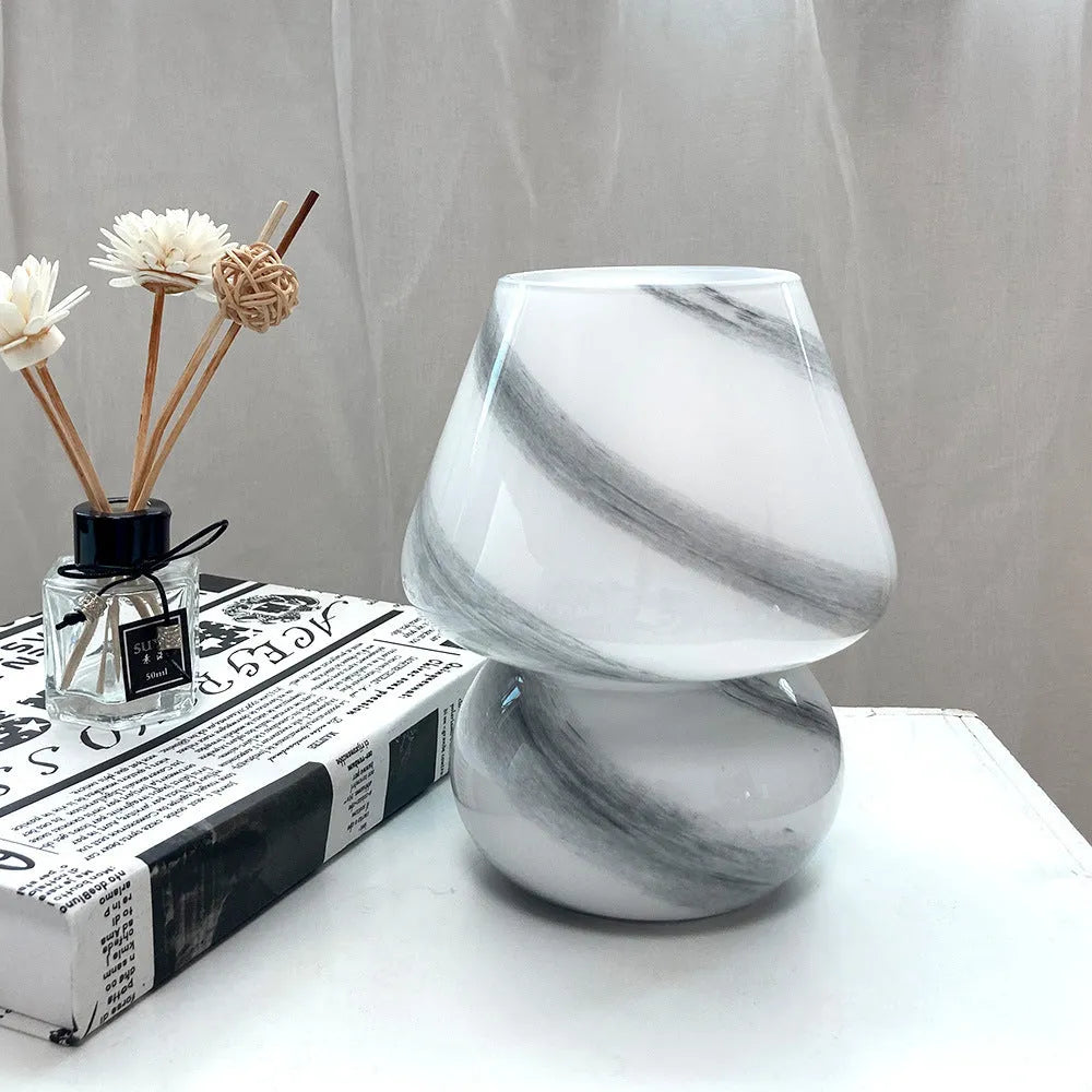 Handmade glass mushroom table lamp in Earth colour finish on a bedside table, showing its compact 15x19cm size