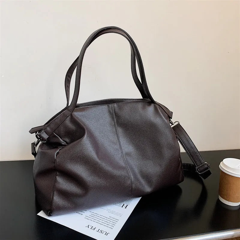 Large soft surface PU messenger tote bag in black with adjustable shoulder strap and zipper opening.