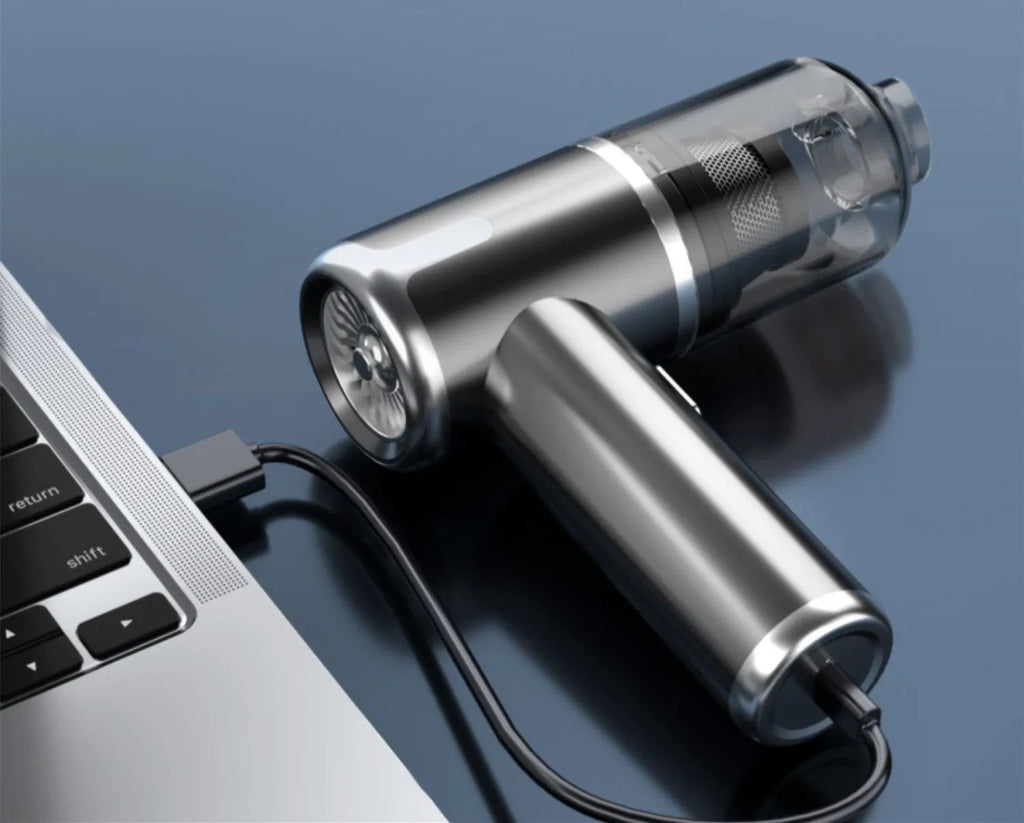 Cordless handheld car vacuum cleaner with attachments on a grey background