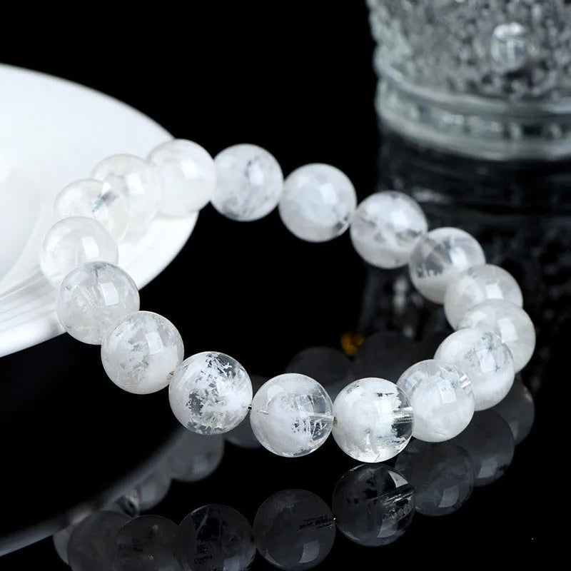 Original design women's crystal bracelet with natural blizzard snowflake round beads on a wrist.
