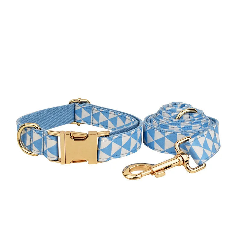 Blue cloth dog vest set with matching collar, leash, and bow tie on a white background
