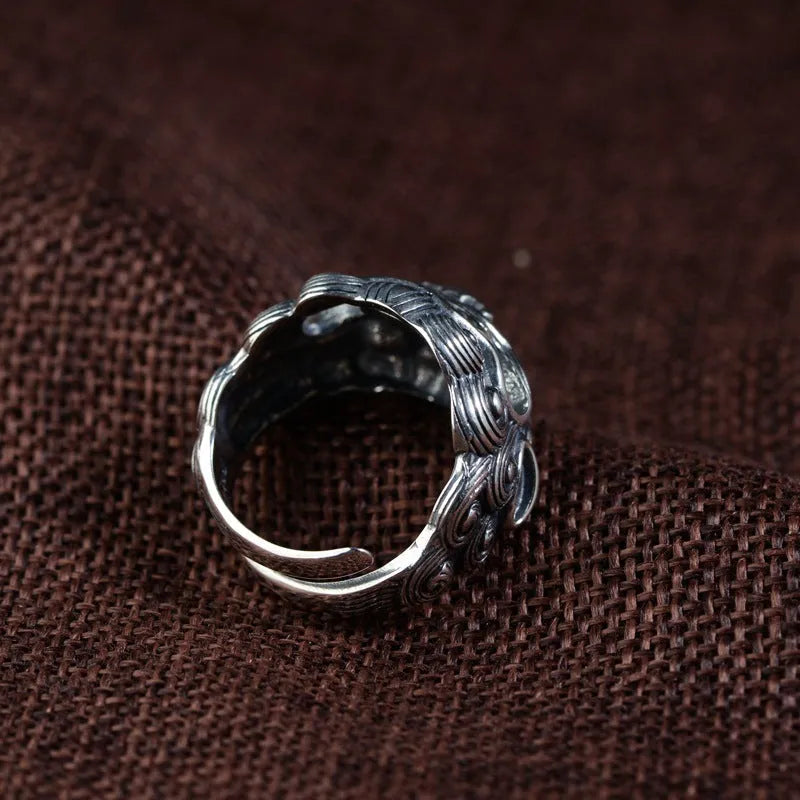 Silver open ring with a detailed Jibeast animal zodiac pattern and diamond design on a white background.