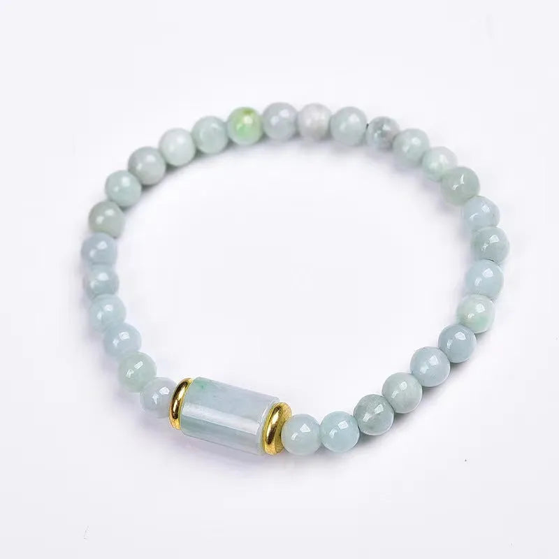 Close-up of a natural emerald green Myanmar jade stone bracelet with round lucky beads on a wrist.