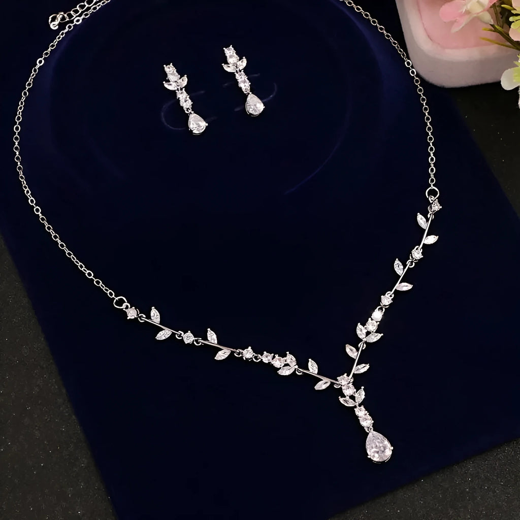 Simple bridal silver alloy love pattern necklace and earrings suite on display, handmade ornament set with ear clip option