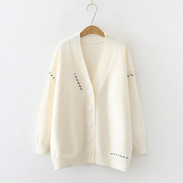 Women's loose-fitting knitted cardigan top coat in black, showing long sleeves and solid colour design.