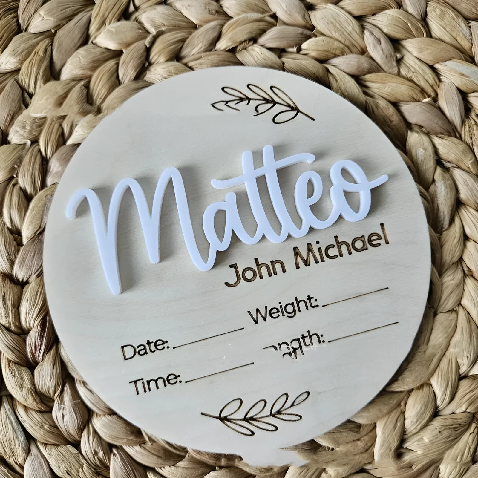 Square wooden newborn name plaque showing baby birth information and surname.