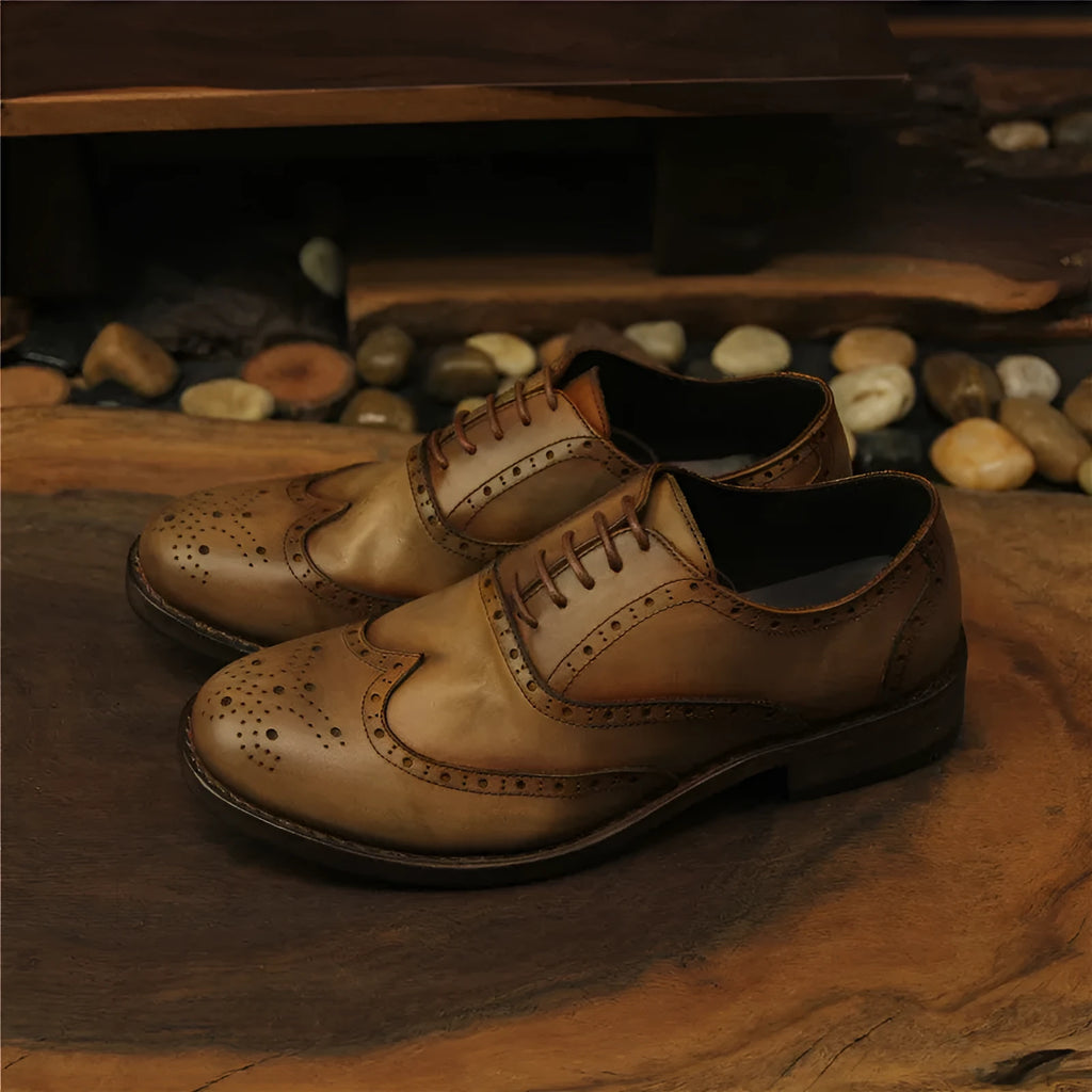 Light brown men's vintage distressed leather lace-up shoes with carved detailing on the upper.