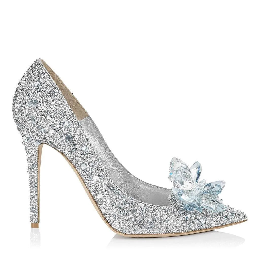 Gold women's pointed toe high heels with rhinestone and sequin decoration on a stiletto heel.
