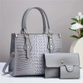 Contrast colour minimalist textured three-piece set showing crossbody bag, wallet, and card holder in burgundy.