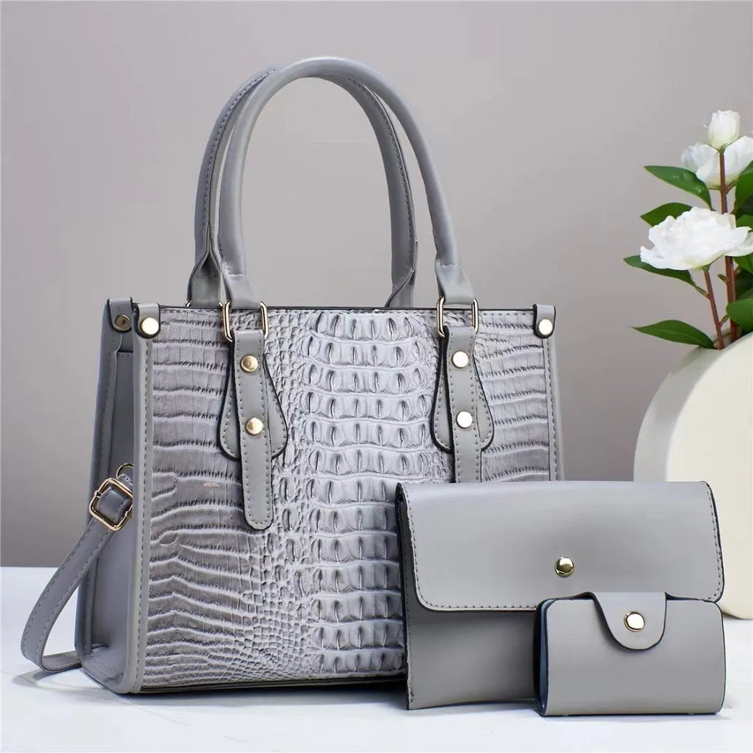 Contrast colour minimalist textured three-piece set showing crossbody bag, wallet, and card holder in burgundy.
