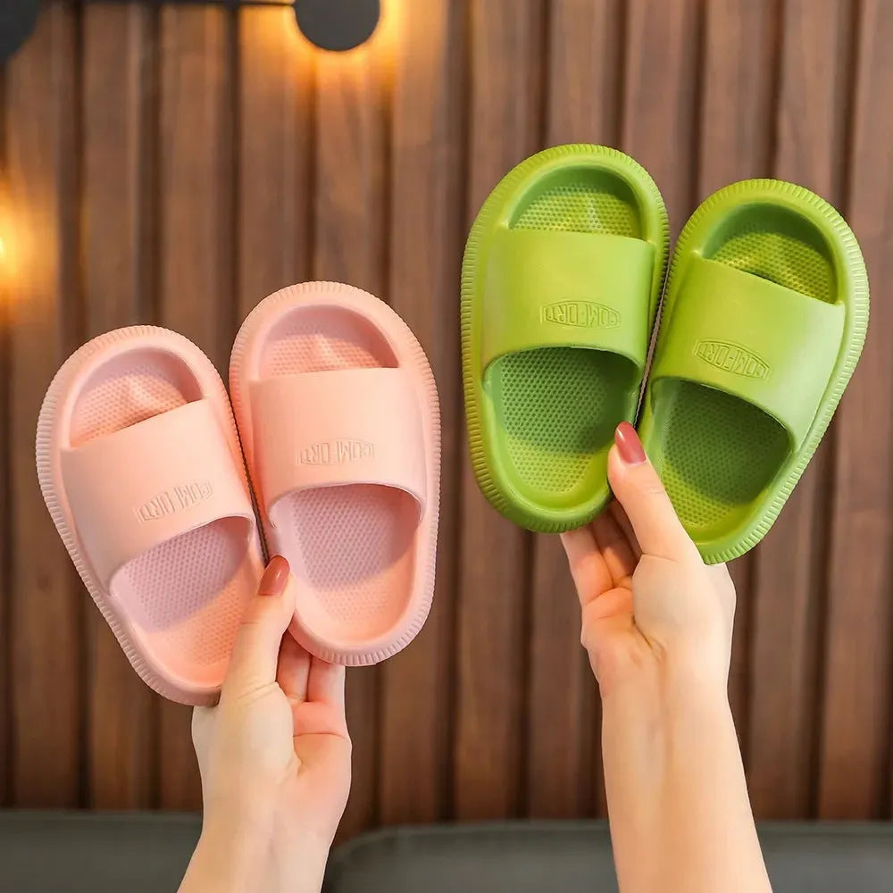 Bright coloured children's EVA slippers with textured sole, shown in blue, green, orange, pink, and yellow.