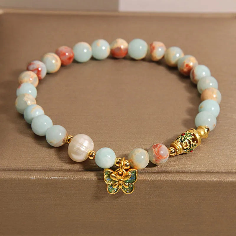 Blue women's bracelet with Shoushan Stone and freshwater pearl butterfly design featuring adjustable closure