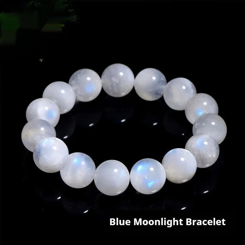 Natural blue moonlight round bead moonstone bracelet on a wrist, showing polished stones.