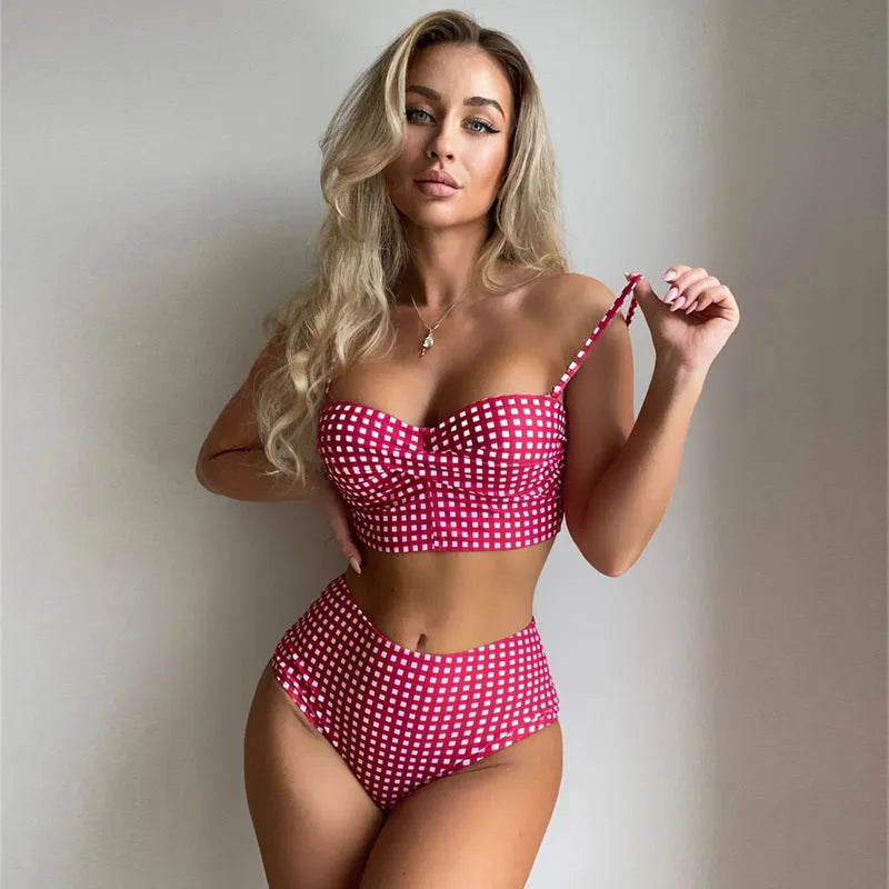 Women's rose red plaid high-waisted bikini set with a split design on the briefs, laid flat.
