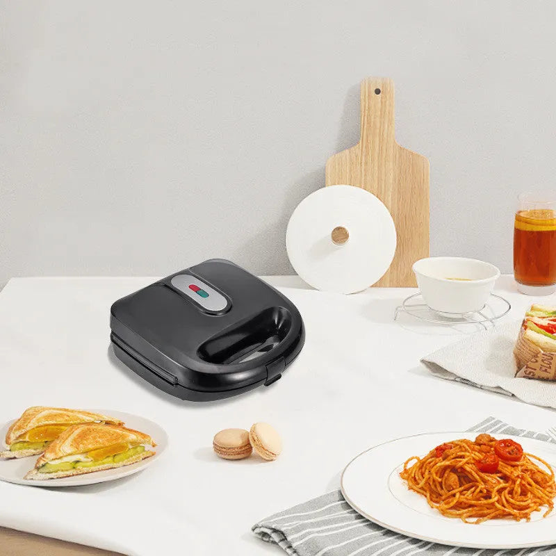 Black electric sandwich maker with double-sided heating, brushed stainless steel lid, and non-stick plates.