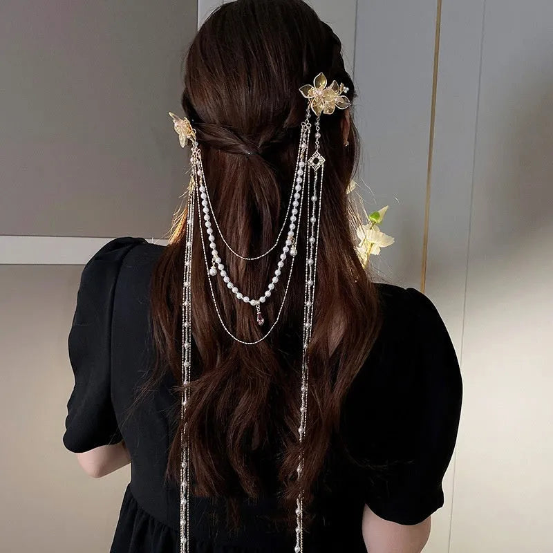 Women's gold pearl diamond flower long tassel hairpin on white background