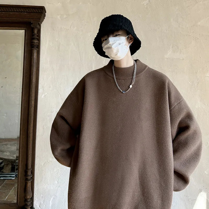 Man wearing a loose grey round neck long sleeve polyester sweater for casual spring or autumn attire.