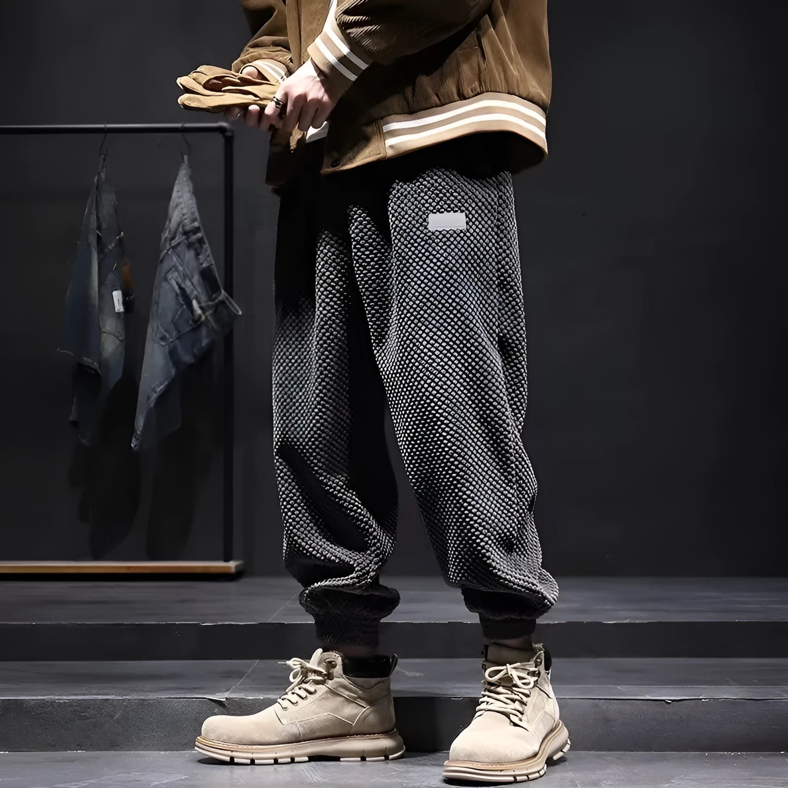 Man wearing grey straight-leg sweatpants with an ankle tie closure.