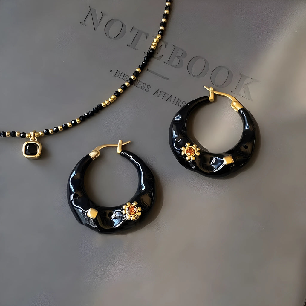 A pair of retro-style alloy ear studs with inlaid rhinestones, shown in black and red colour options.