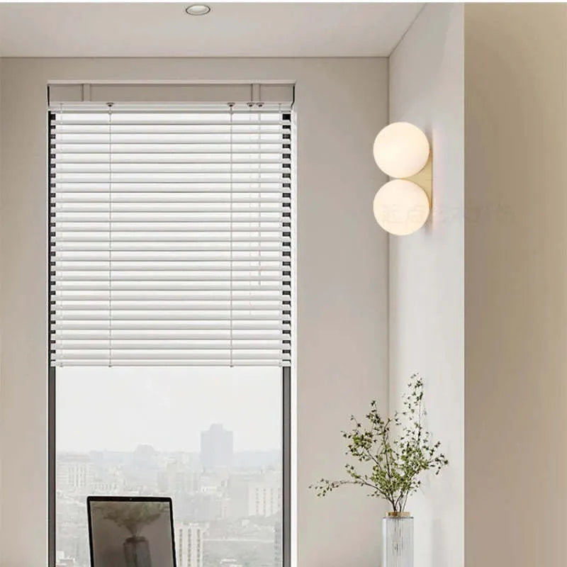 Simple glass ball wall lamp with gold finish and iron frame for bedroom bedside