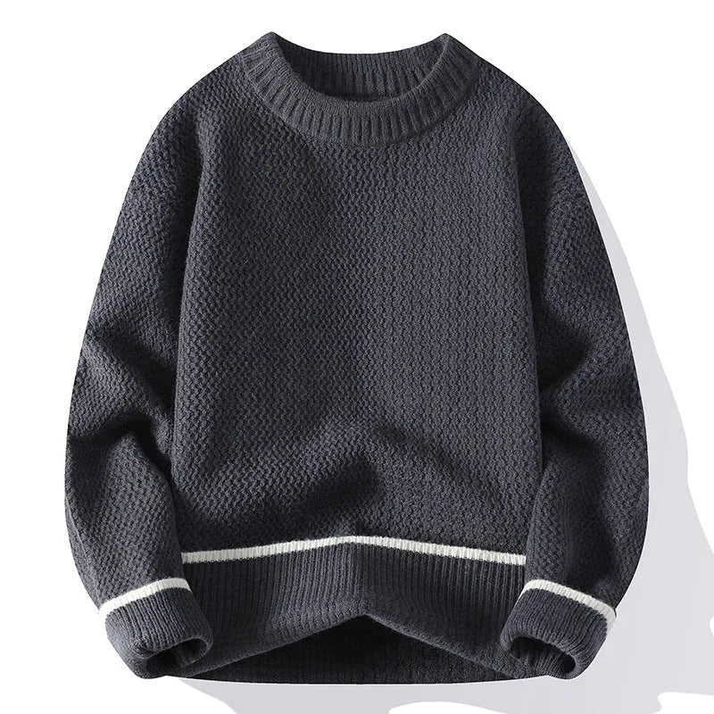 A man wearing a grey loose-fitting round neck casual pullover sweater.