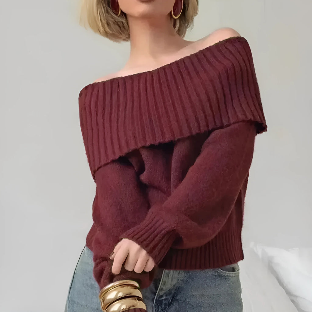 Woman wearing a grey off-the-shoulder sweater with a raised 3D texture pattern.
