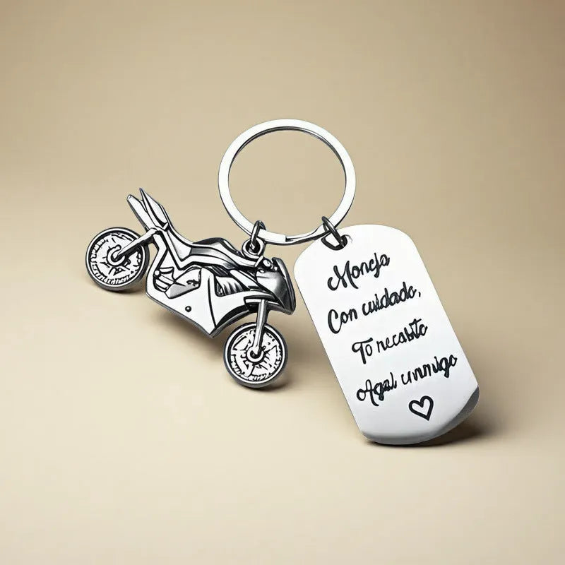 Stainless steel motivational keychain for motorcycle keys with a flannel storage bag.