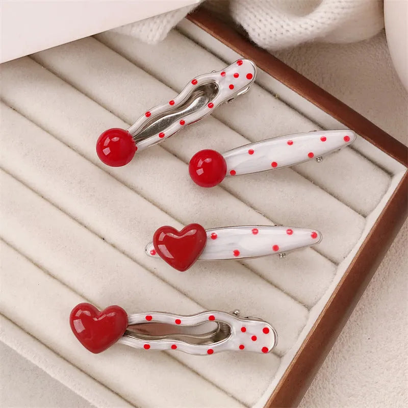 Red stereo love heart-shaped hairpin with French retro dots and willow leaf decoration on a white background.