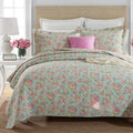 Quilted cotton bed cover set with printed pattern on bed with matching pillowcases