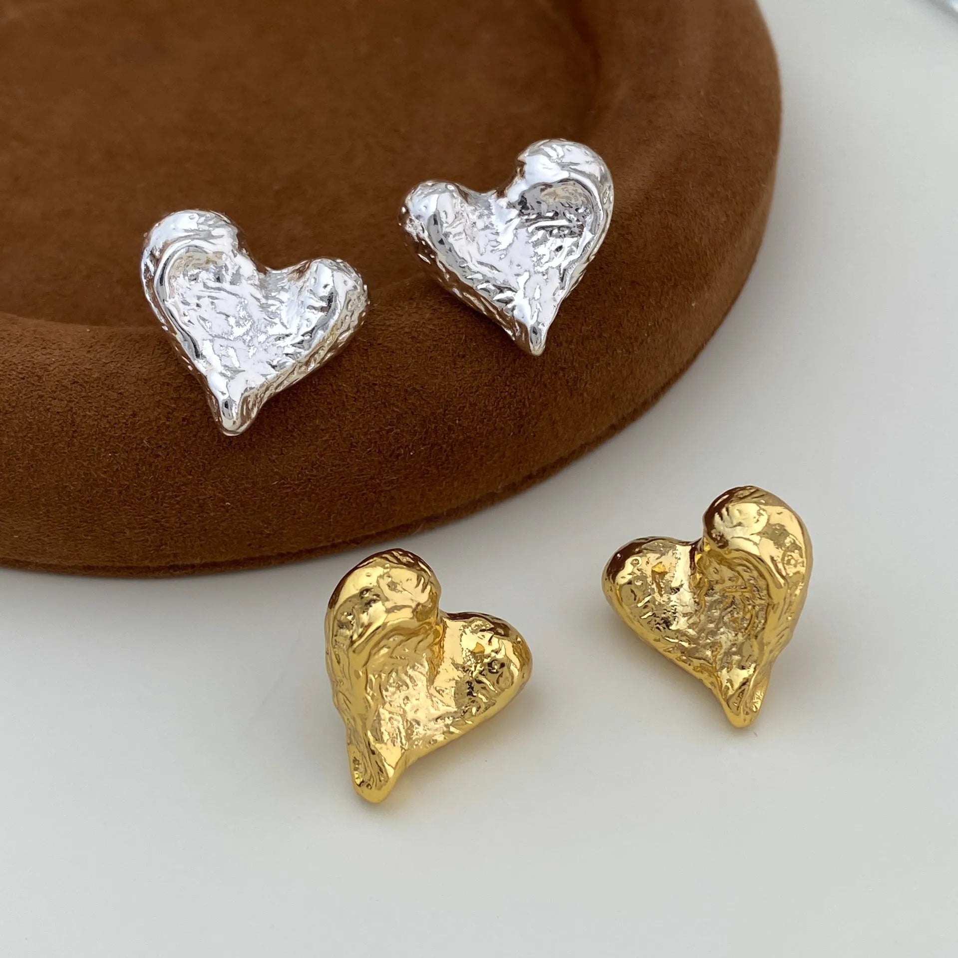 Minimalist silver heart-shaped stud earrings for women on copper base