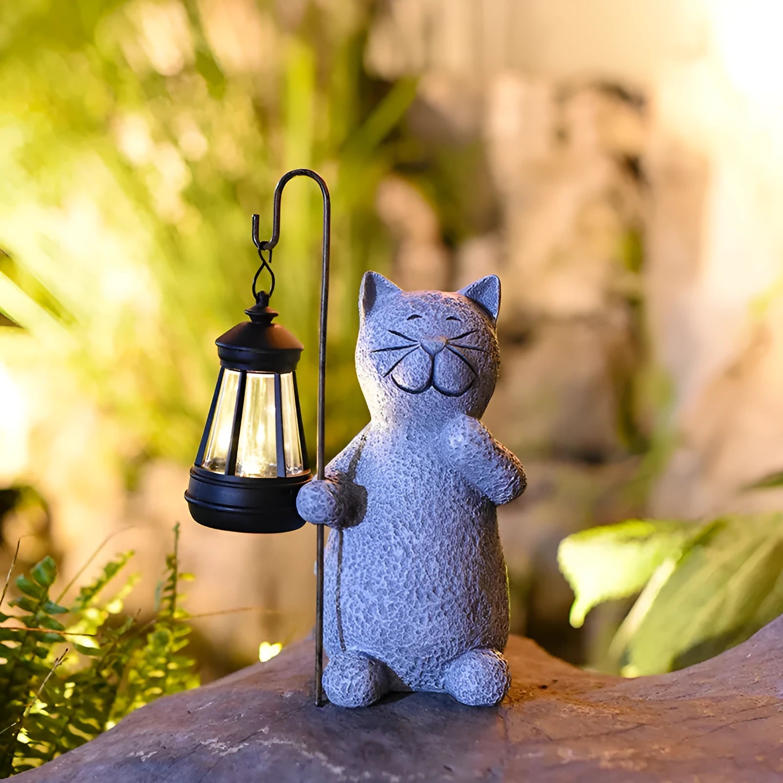 Solar-powered garden light with decorative resin kitten ornament lifting a lamp.