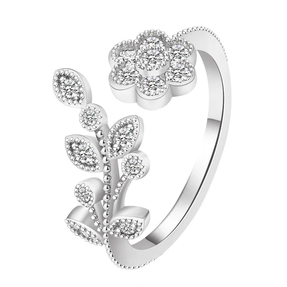 Women's open mouth ring with flower and leaf design in gold or white colour with diamond treatment