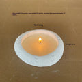White cement candlestick ornament with fair-faced finish holding a candle
