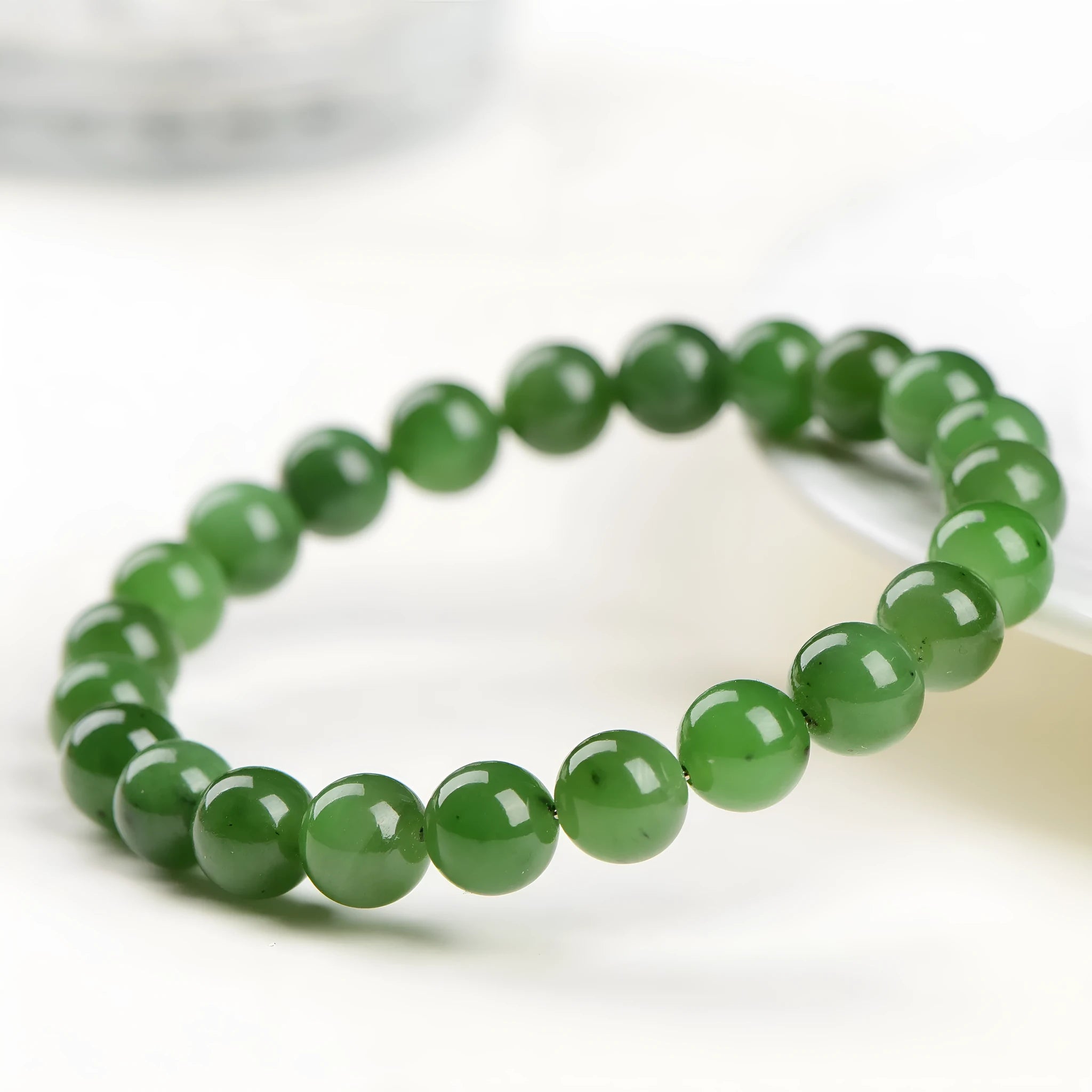 Natural Hetian jade beaded bracelet with polished jasper stones in five size options on a white background.