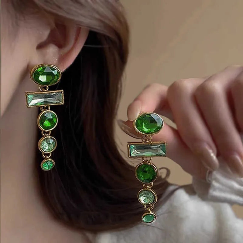 A pair of green gradient geometric alloy stud earrings with inlaid zircon stones and a dangling tassel.