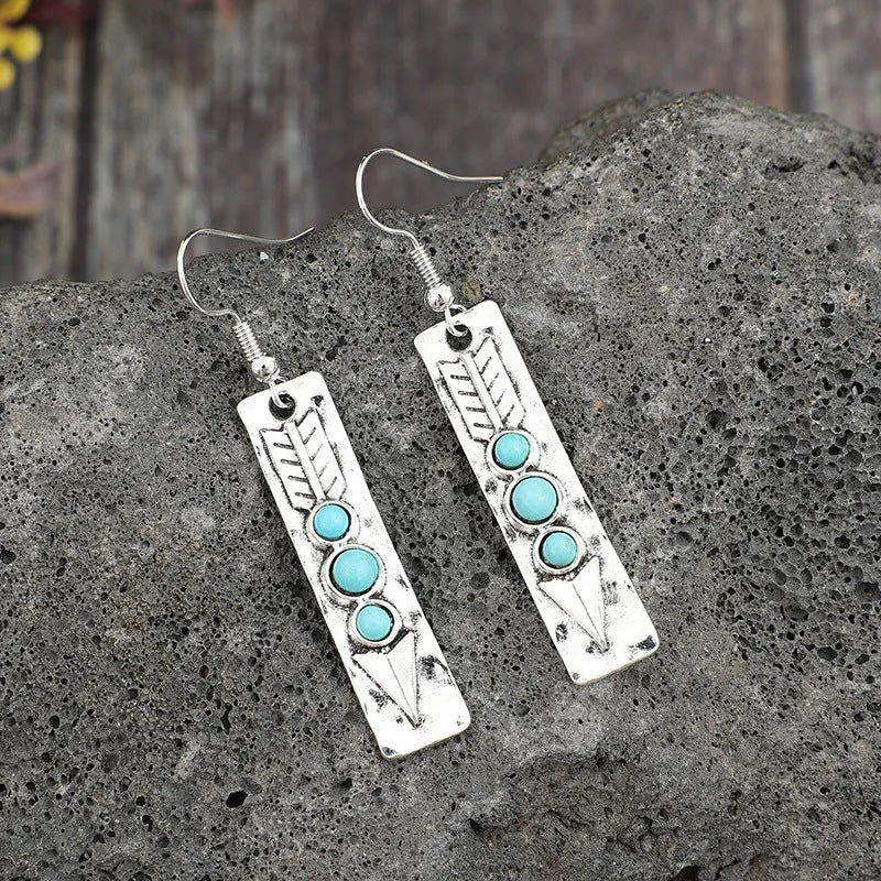 Silver geometric drop earrings with turquoise inlay detailing on long strip design