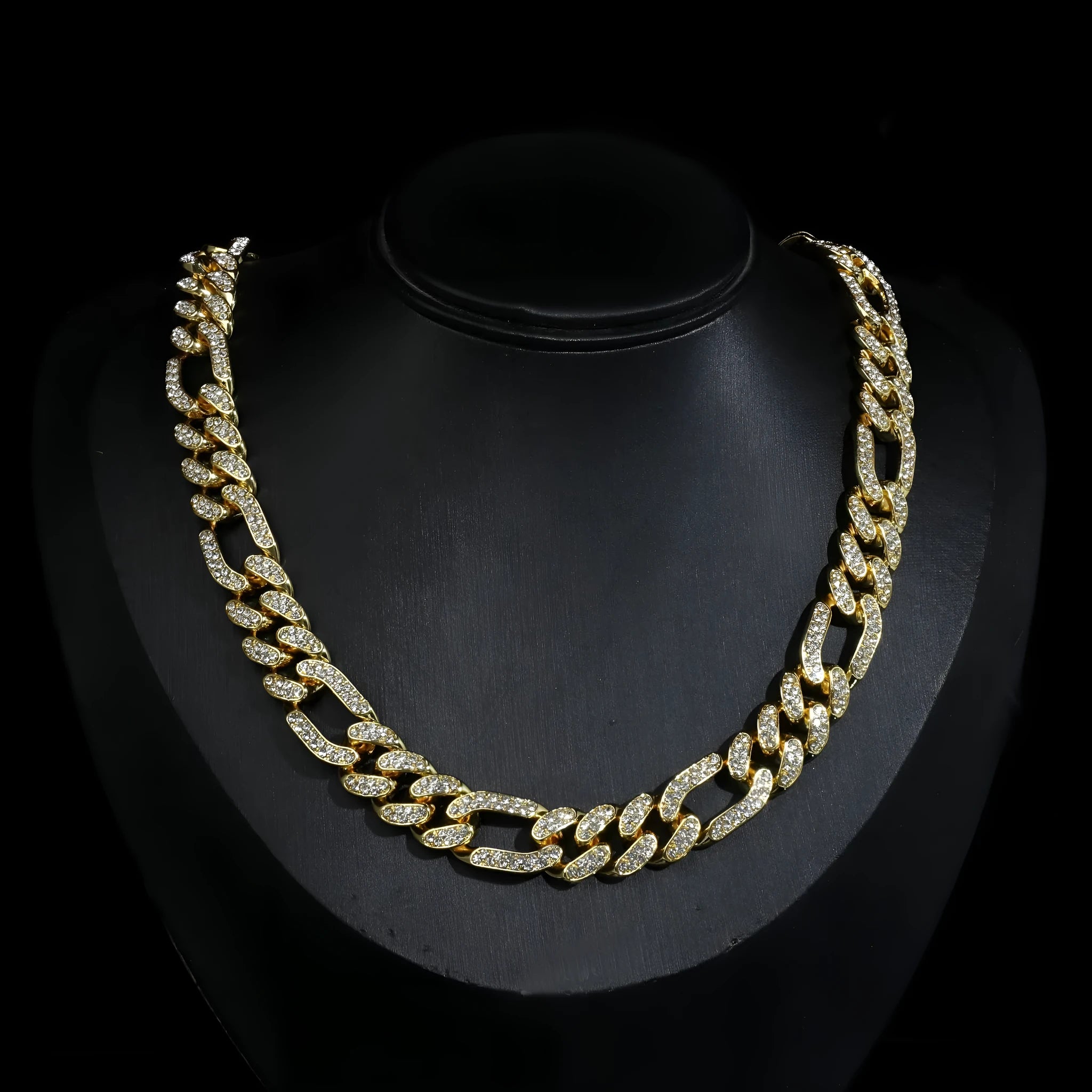 Rap style figaro chain necklace with geometric rhinestone pendant in silver colour on a plain background