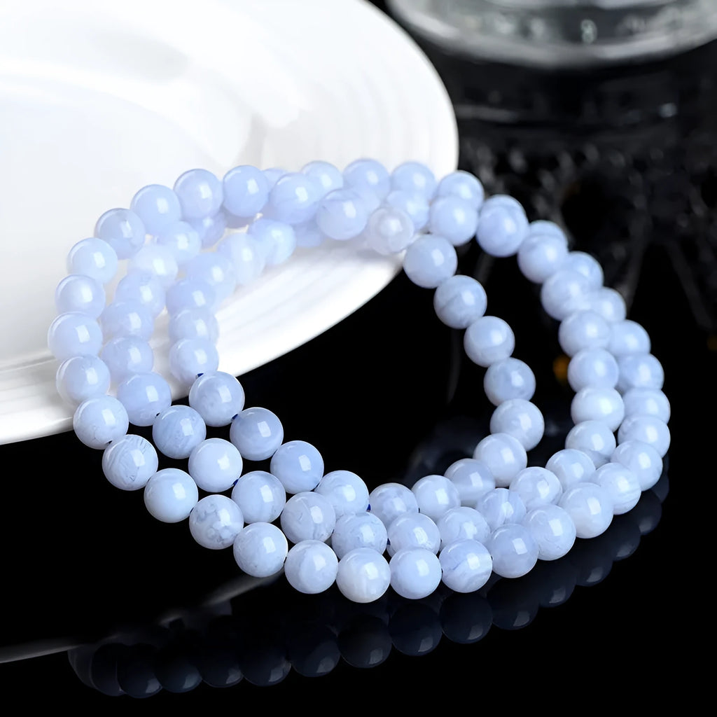 Blue agate beaded bracelet with Ruyi design elements and scattered striped beads