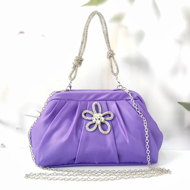 Soft black women's large-capacity dinner bag with chain strap and shell shape.